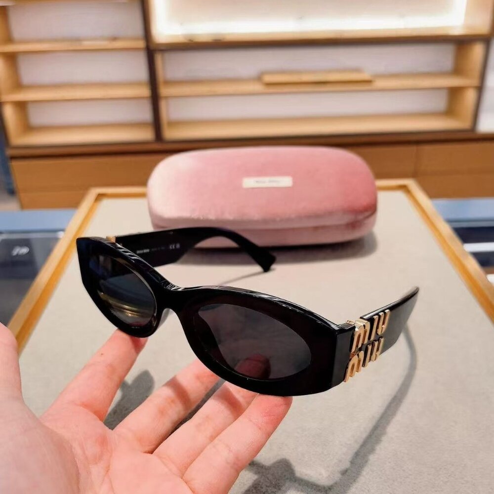 Miu Miu Black Cat-Eye Sunglasses with Gold Logo Accents